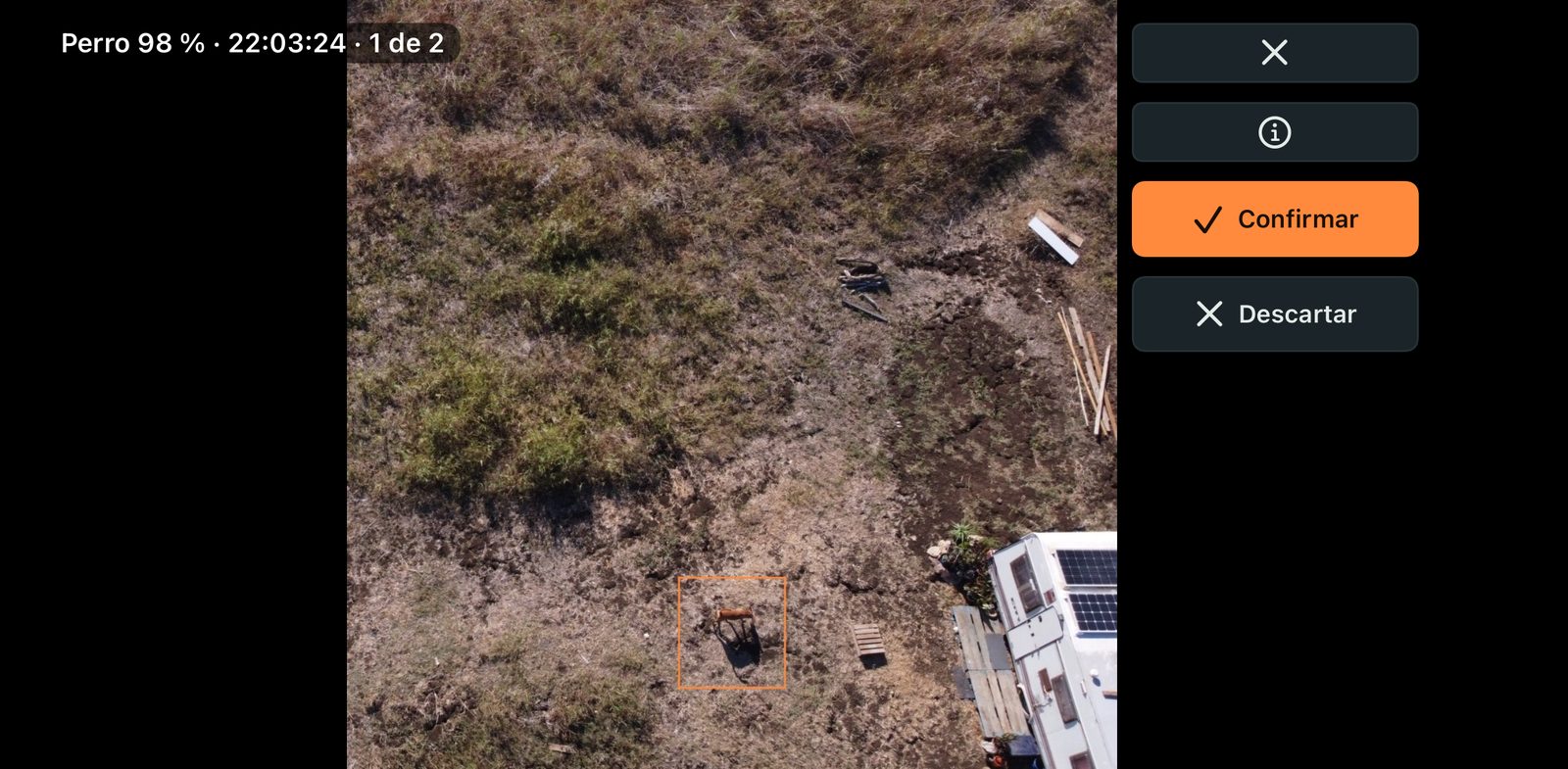 A possible dog found by the AI in a drone photo, marked with an orange box, with Confirm and Discard buttons